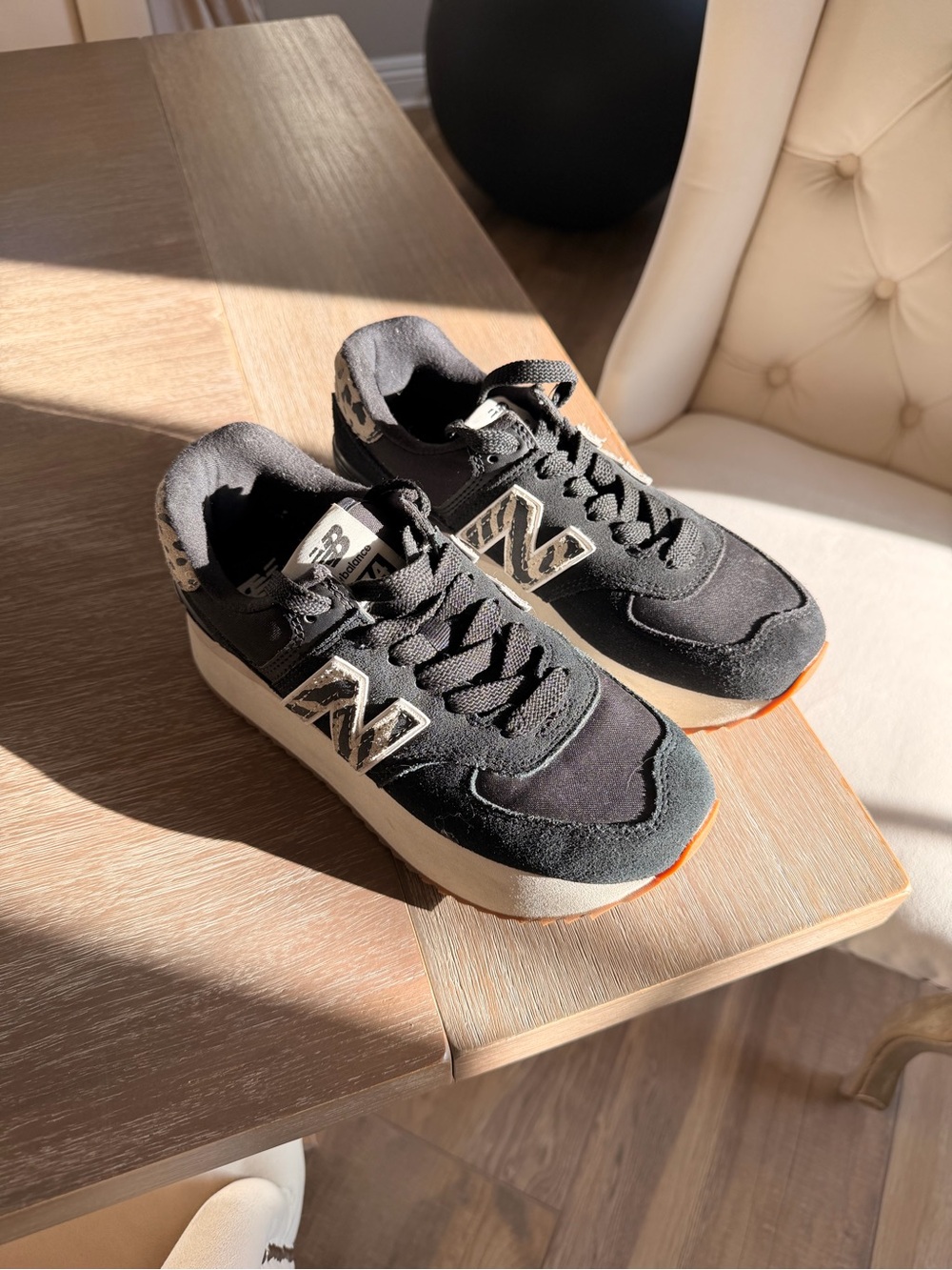 New Balance Black Athletic Sneakers with Cream Logo and Orange Outsole